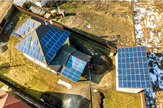 Large residential roof with solar panels installed across available roof space 

