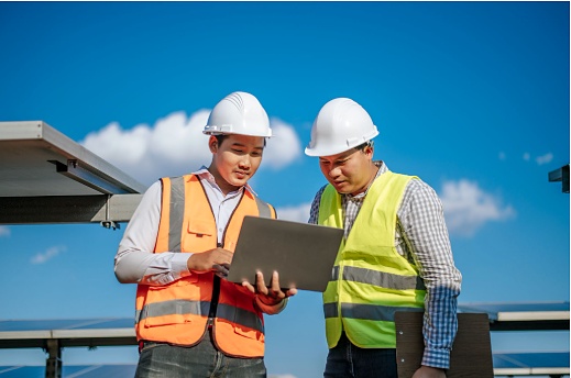 Solar engineers inspecting a utility-scale solar farm